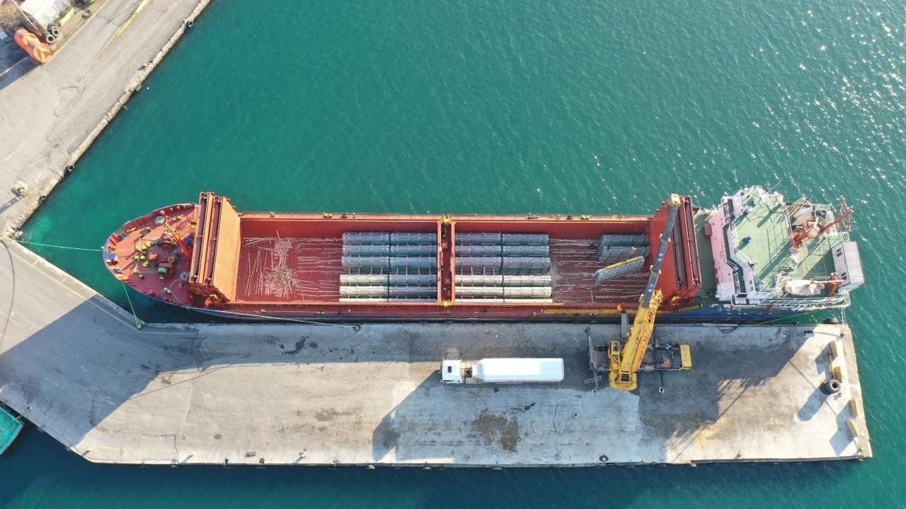 General cargo vessel alongside during steel discharge, aerial view